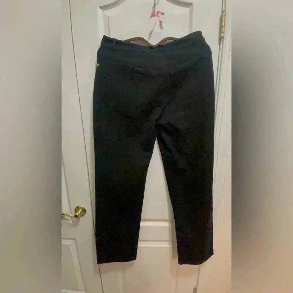 St. John black jeans in new condition . Gorgeous hardware around the belts .